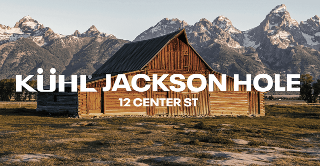 A cabin with mountains in the background.