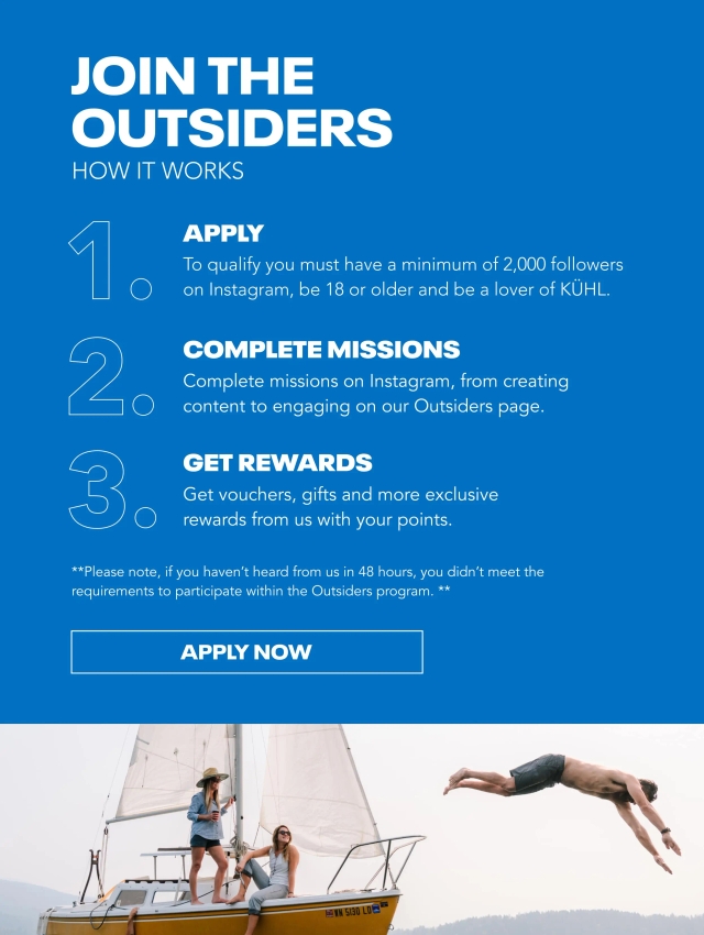 Three people at a lake having fun wearing Kühl clothes.